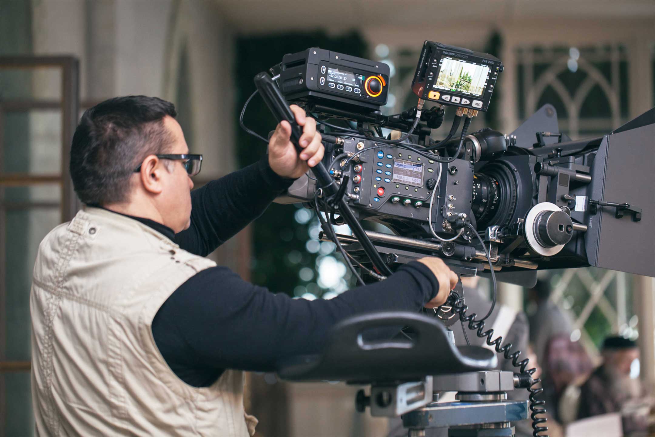 The right film crew uses a camera man using a professional video camera